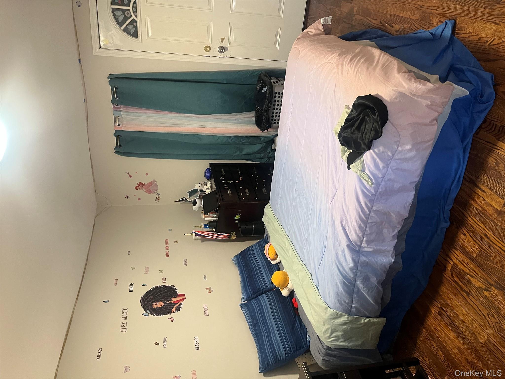 137-15 220th Place Queens, NY 11413 - Photo 17 of 28 a bedroom with a bed and a large mirror