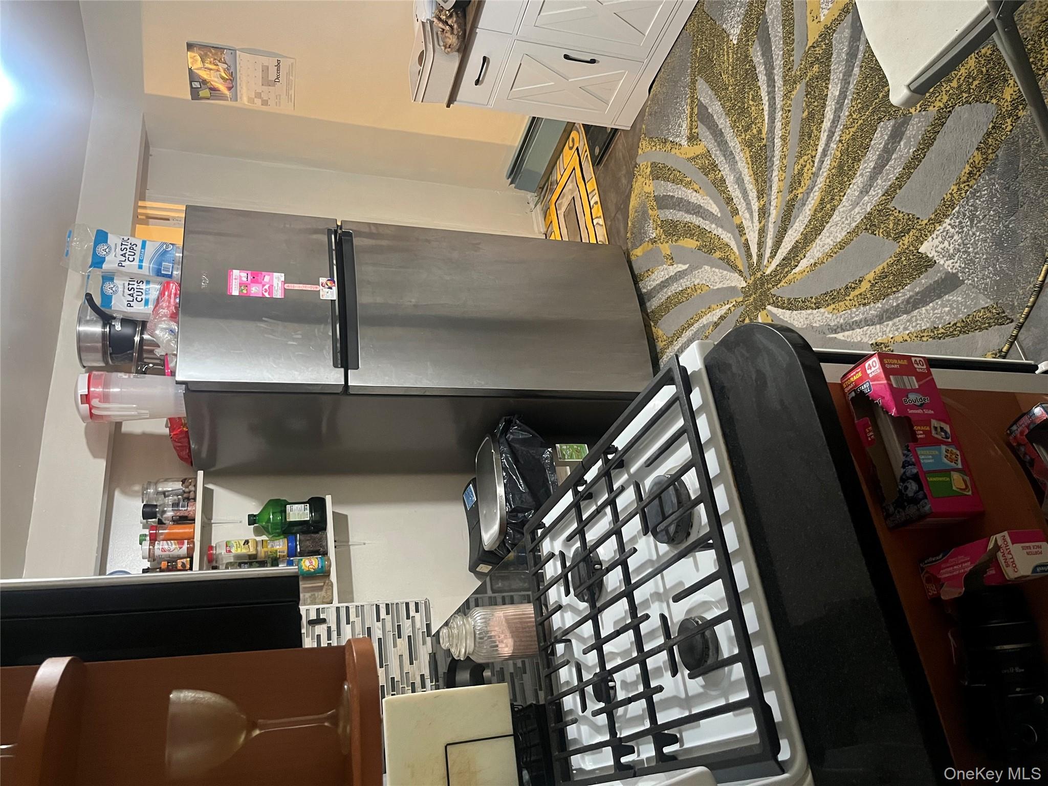 137-15 220th Place Queens, NY 11413 - Photo 25 of 28 a kitchen with a refrigerator and a stove