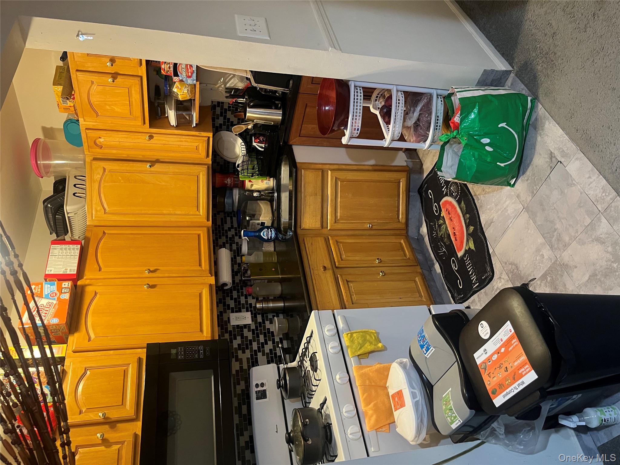 137-15 220th Place Queens, NY 11413 - Photo 6 of 28 a kitchen with stainless steel appliances a stove a sink and a microwave