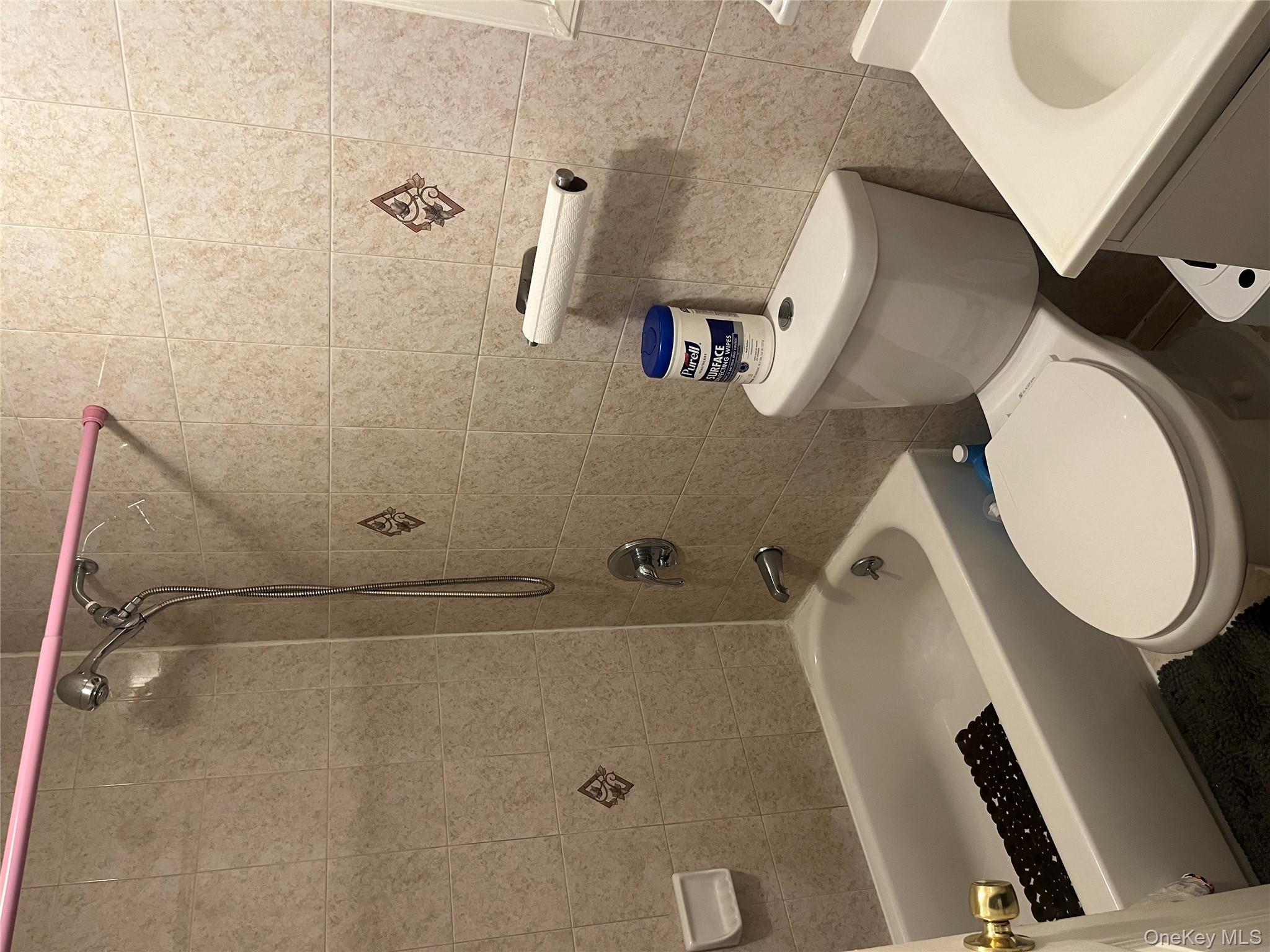 137-15 220th Place Queens, NY 11413 - Photo 8 of 28 a white toilet sitting next to a bath tub