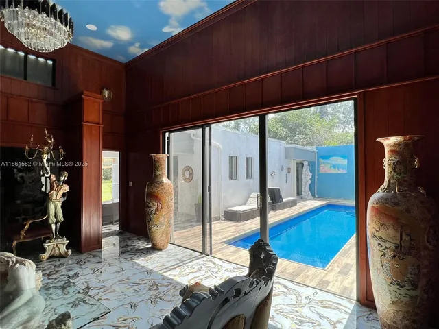 a bedroom with furniture and a large window