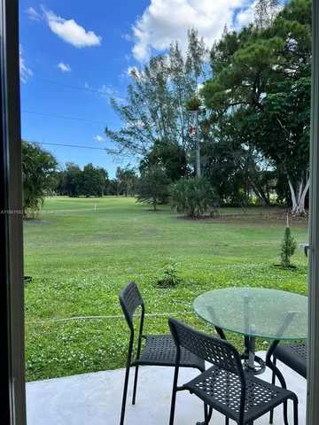 a view of a table and chairs in the garden