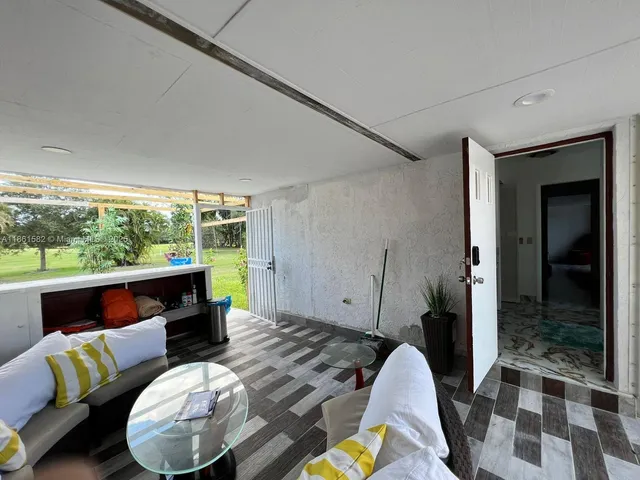 a view of a house with wooden floor and a yard