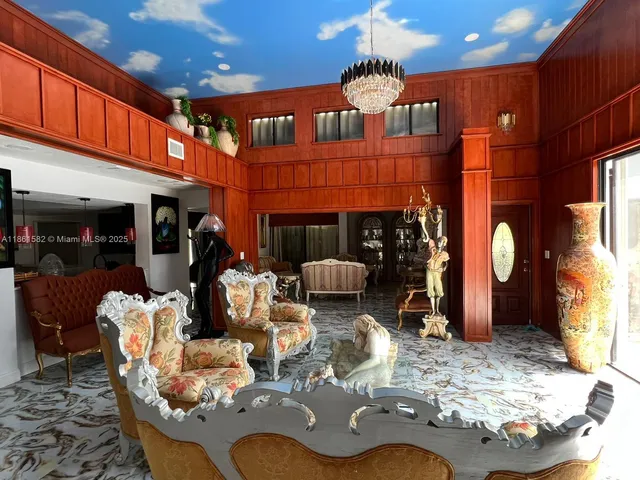 a dining room with furniture a chandelier and wooden floor