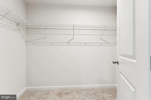 an empty room with closet and windows