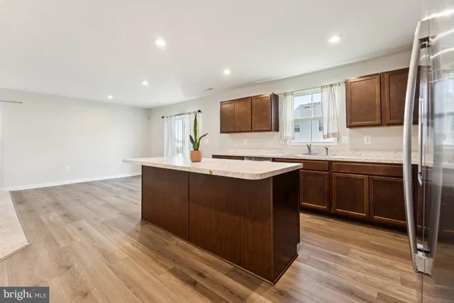 a kitchen with stainless steel appliances granite countertop a stove a sink and a refrigerator
