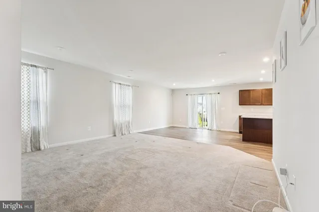 a view of empty room with a fireplace