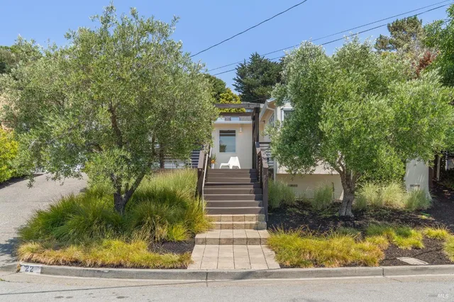 a front view of a house with garden