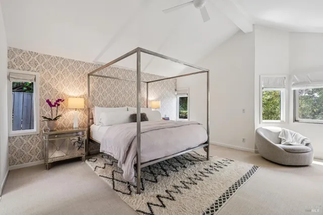 a spacious bedroom with a bed and a couch