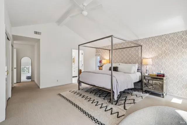 a bed room with a bed and a mirror