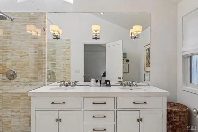 a bathroom with a sink double vanity and a mirror