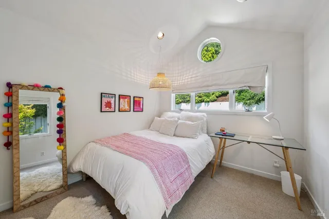 a bedroom with a bed and a window