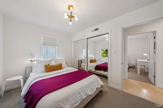 a bedroom with a bed and lamp