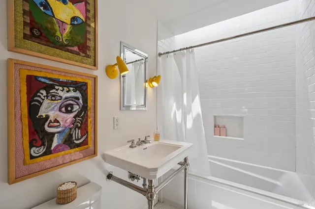 a bathroom with a sink a mirror and a shower