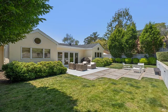 a view of a house with backyard and sitting area