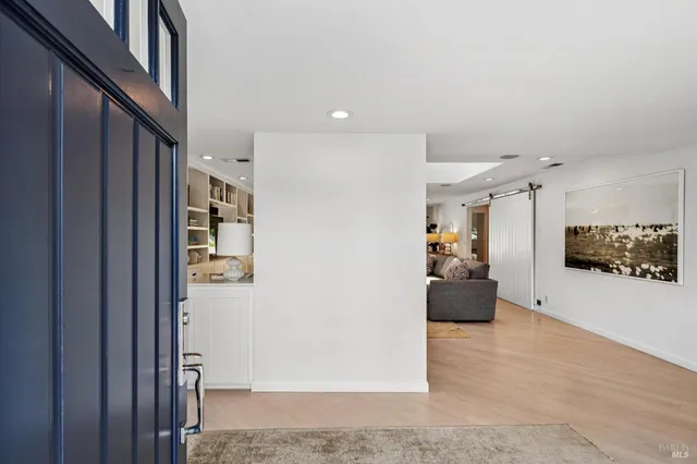 a view of a hallway with furniture and a living room