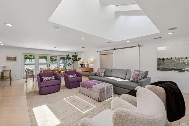 a living room with furniture and a view of kitchen