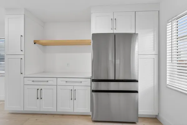 a kitchen with cabinets and white refrigerator