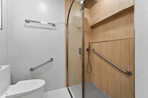 a bathroom with a toilet and a shower
