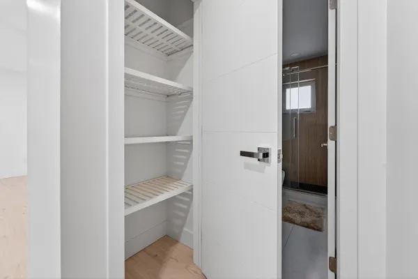 a bathroom with a walk in closet and a window