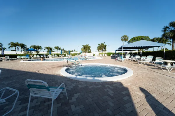 a view of a swimming pool with an outdoor seating