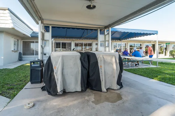 a view of a house with backyard and porch