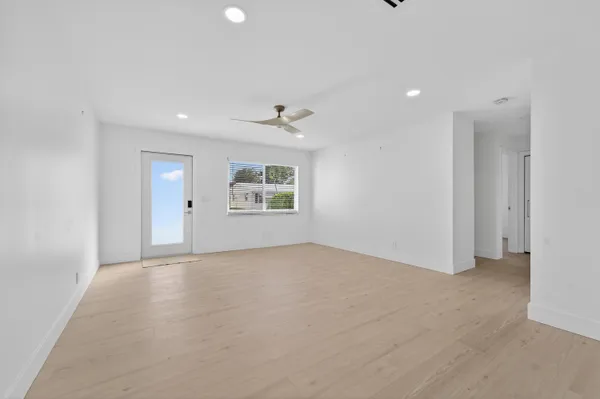 an empty room with windows and closet