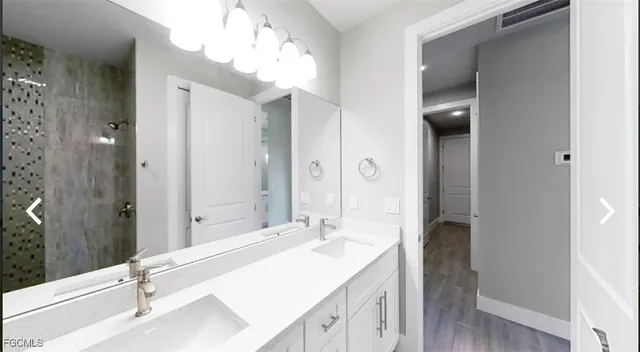 a bathroom with a tub sink and mirror