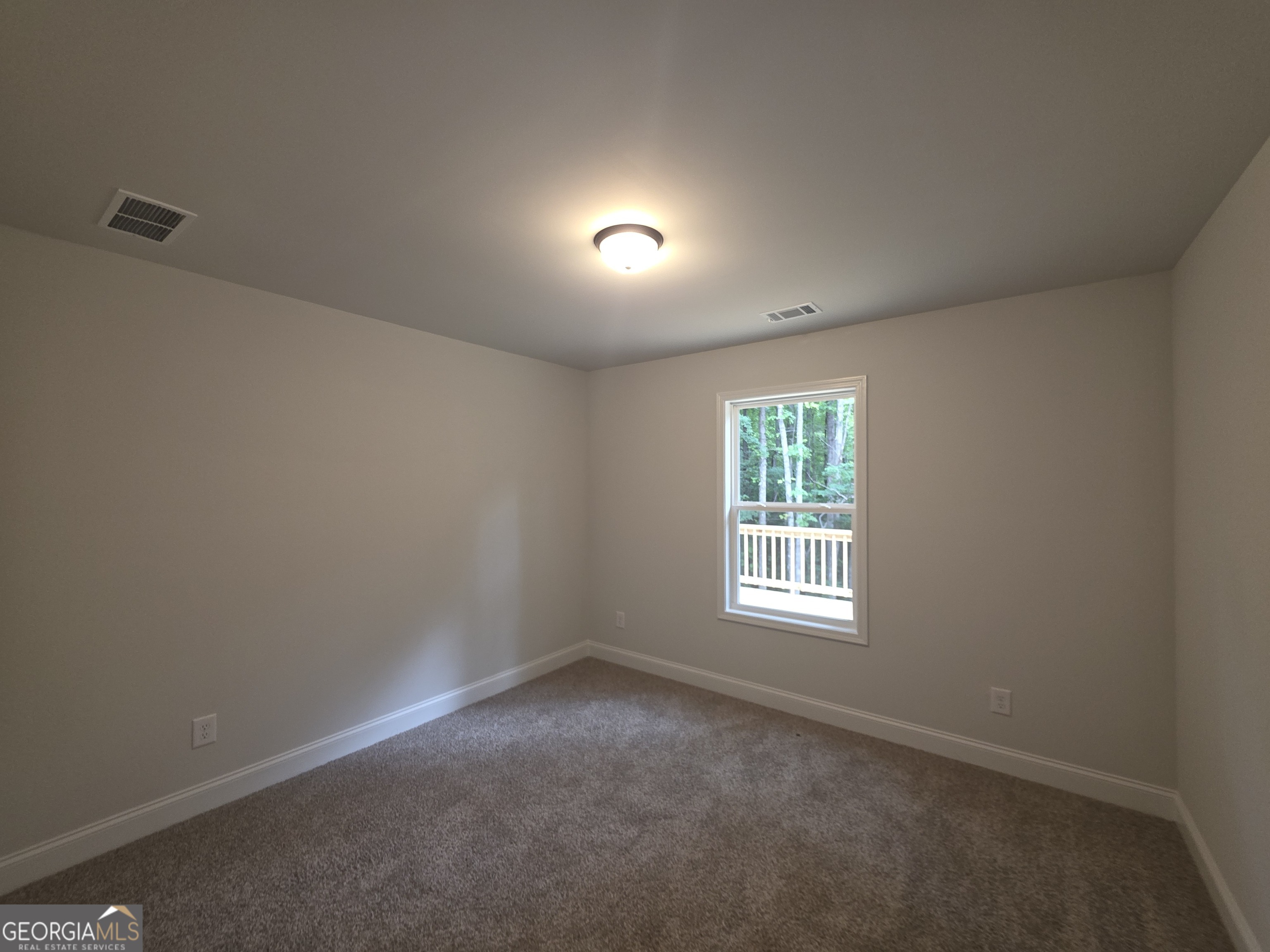 546 Hargrove Lake Road, Unit 2B Arnoldsville, GA 30619 - Photo 12 of 14 an empty room with a window and wooden floor