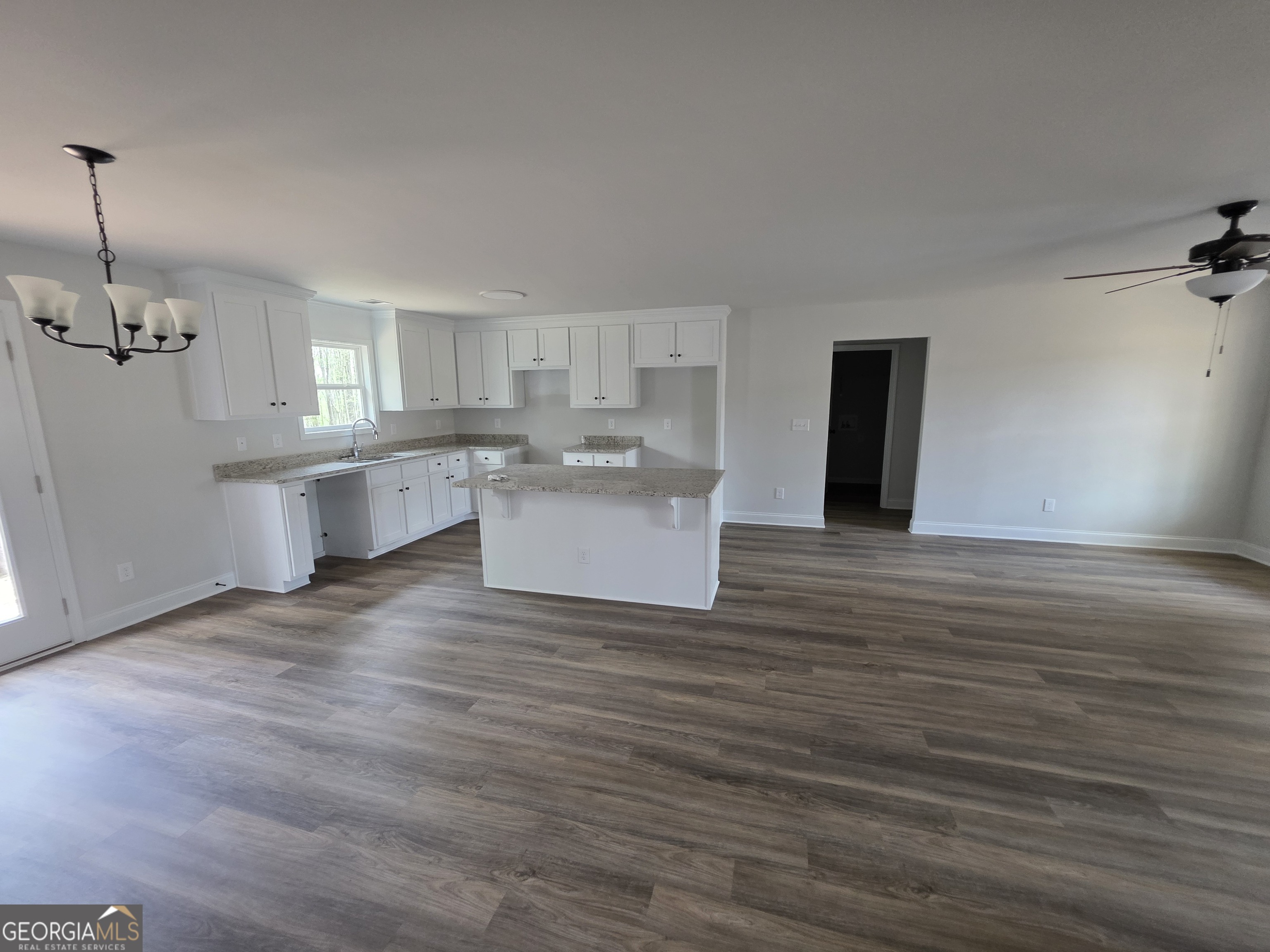 546 Hargrove Lake Road, Unit 2B Arnoldsville, GA 30619 - Photo 3 of 14 a view of a kitchen with a sink wooden cabinets and a refrigerator