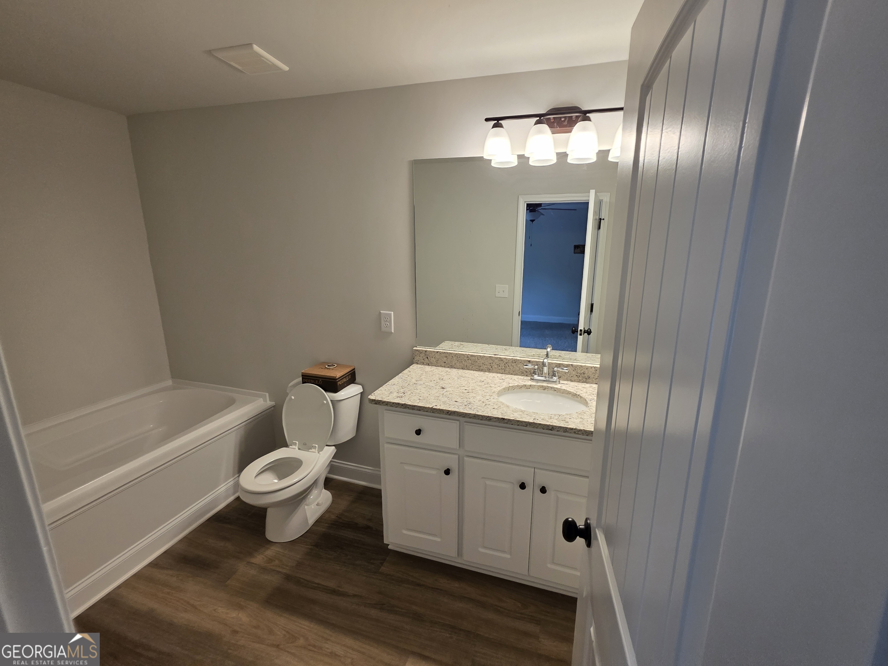 546 Hargrove Lake Road, Unit 2B Arnoldsville, GA 30619 - Photo 5 of 14 a bathroom with a granite countertop toilet a sink and bathtub