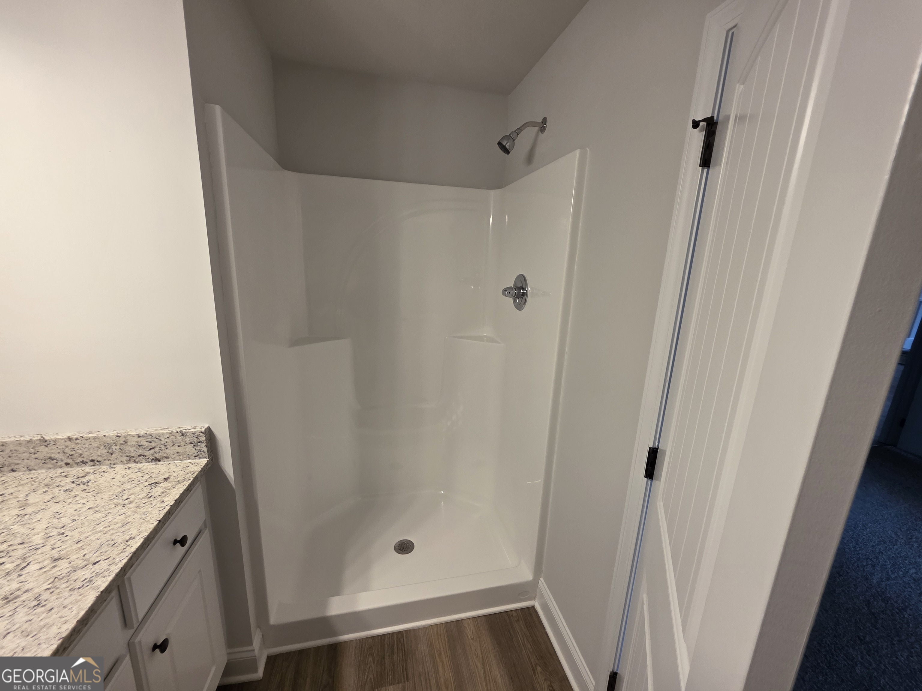 546 Hargrove Lake Road, Unit 2B Arnoldsville, GA 30619 - Photo 6 of 14 a bathroom with a granite countertop shower and a sink