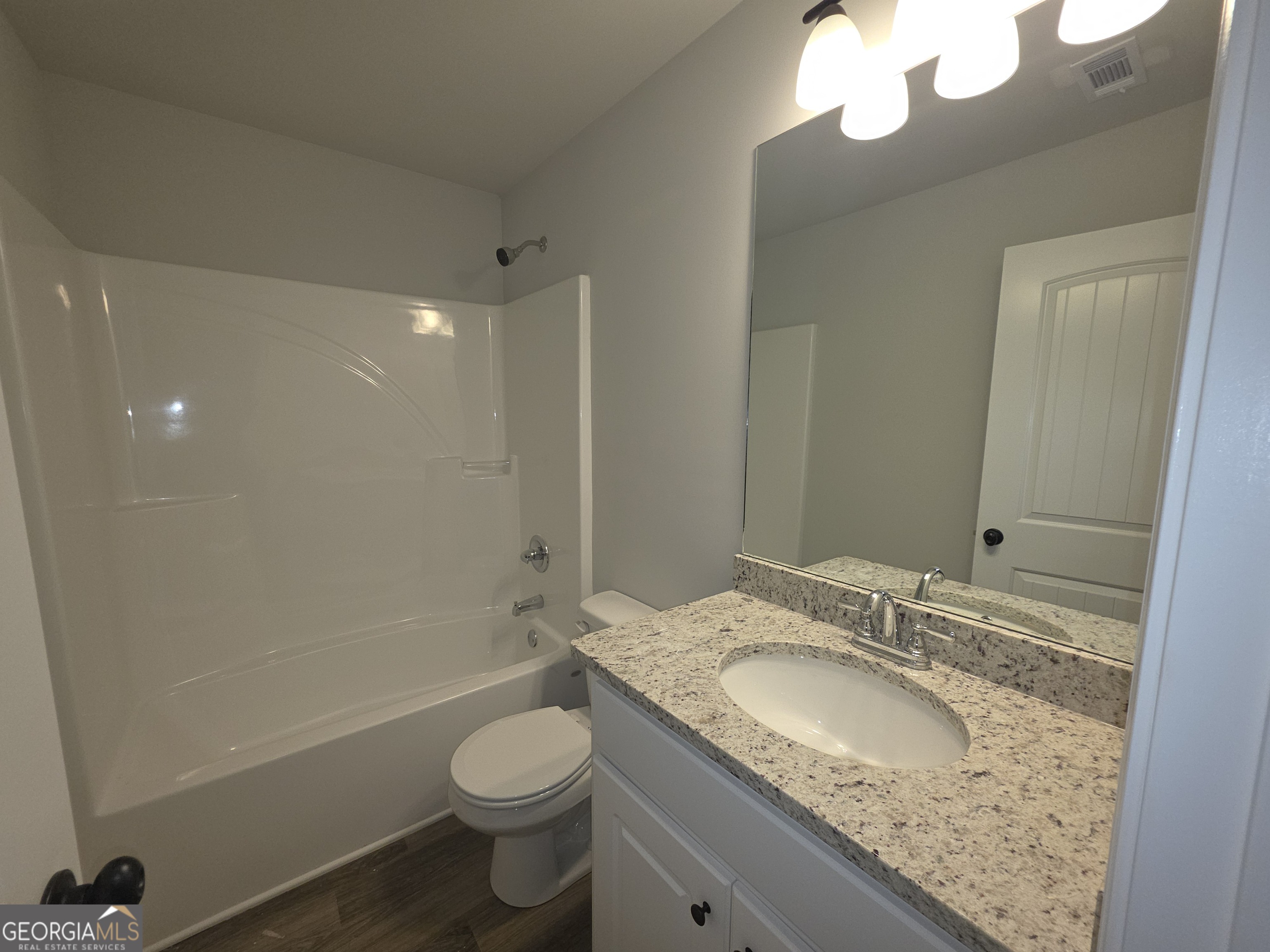 546 Hargrove Lake Road, Unit 2B Arnoldsville, GA 30619 - Photo 10 of 14 a bathroom with a granite countertop sink toilet and shower