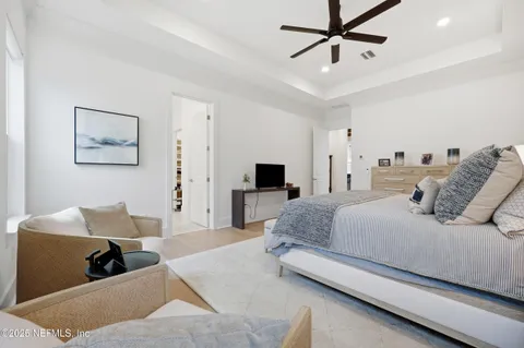 a bedroom with a large bed and a couch