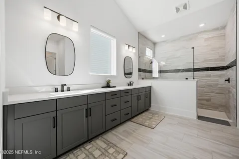 a spacious bathroom with a double vanity sink and a mirror