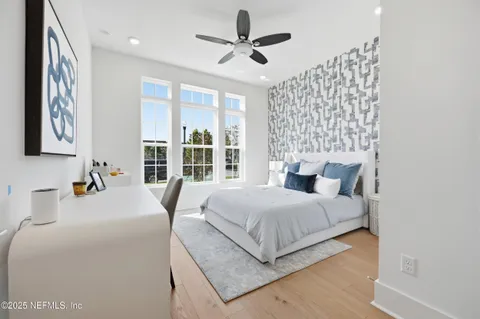 a bedroom with bed and a chandelier