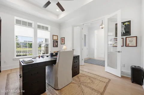 a view of a livingroom with workspace and a window