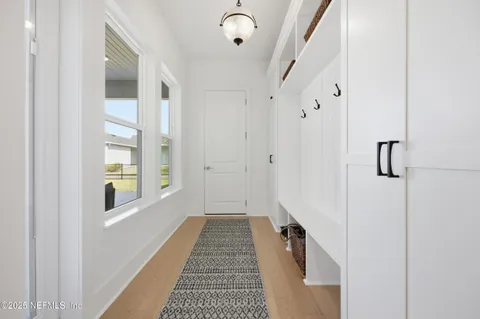 a view of a hallway with windows and entryway