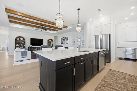 a kitchen with stainless steel appliances granite countertop a sink refrigerator and cabinets