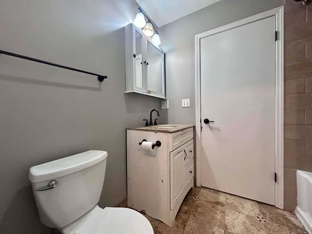 a white toilet sitting next to a bathroom sink