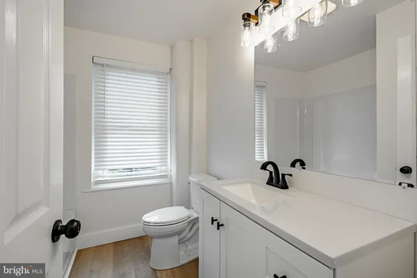 a bathroom with a bathtub toilet and window