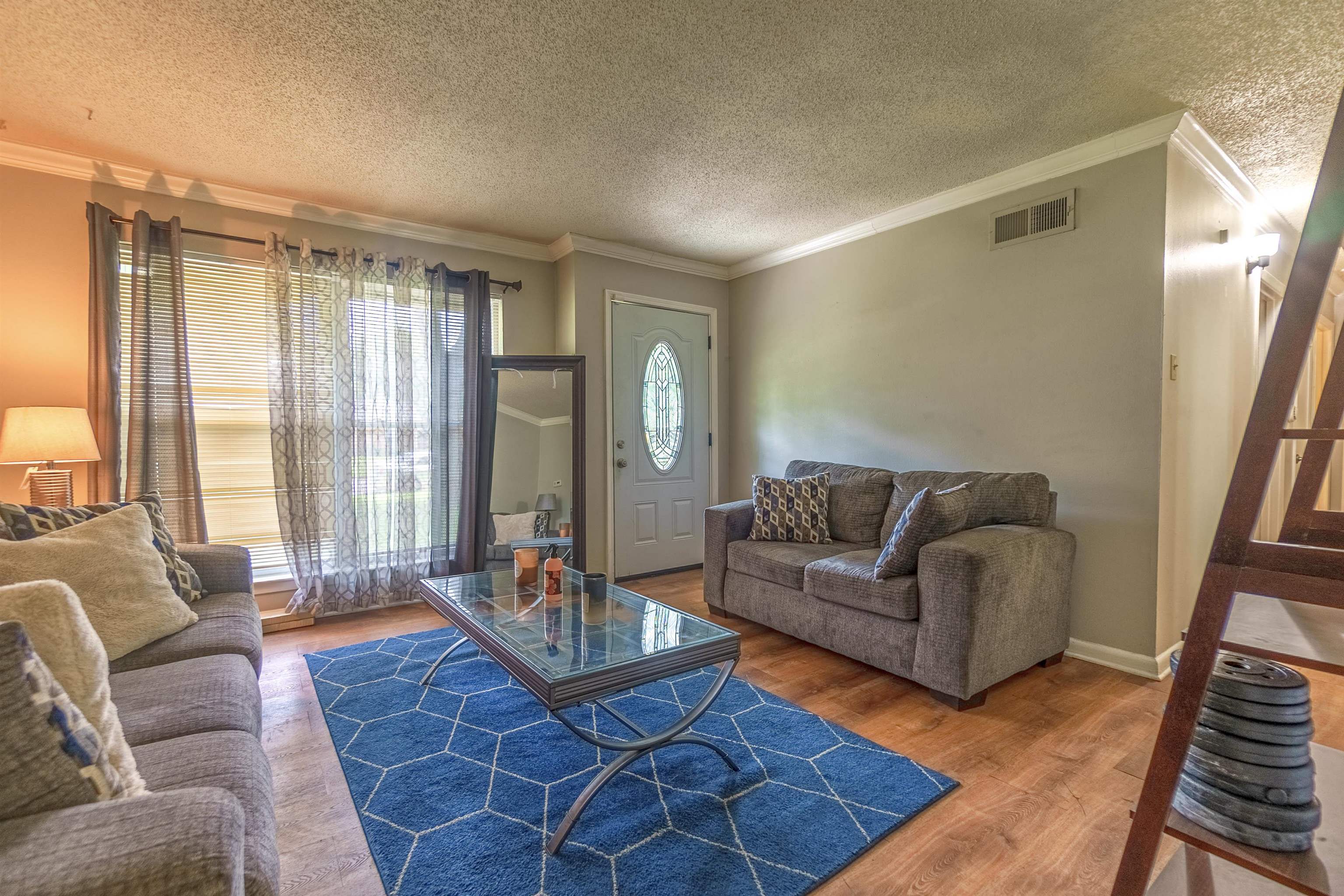 1950 Victoria Road Memphis, TN 38116 - Photo 15 of 25 Living area with wood finished floors, ornamental molding, and a textured ceiling
