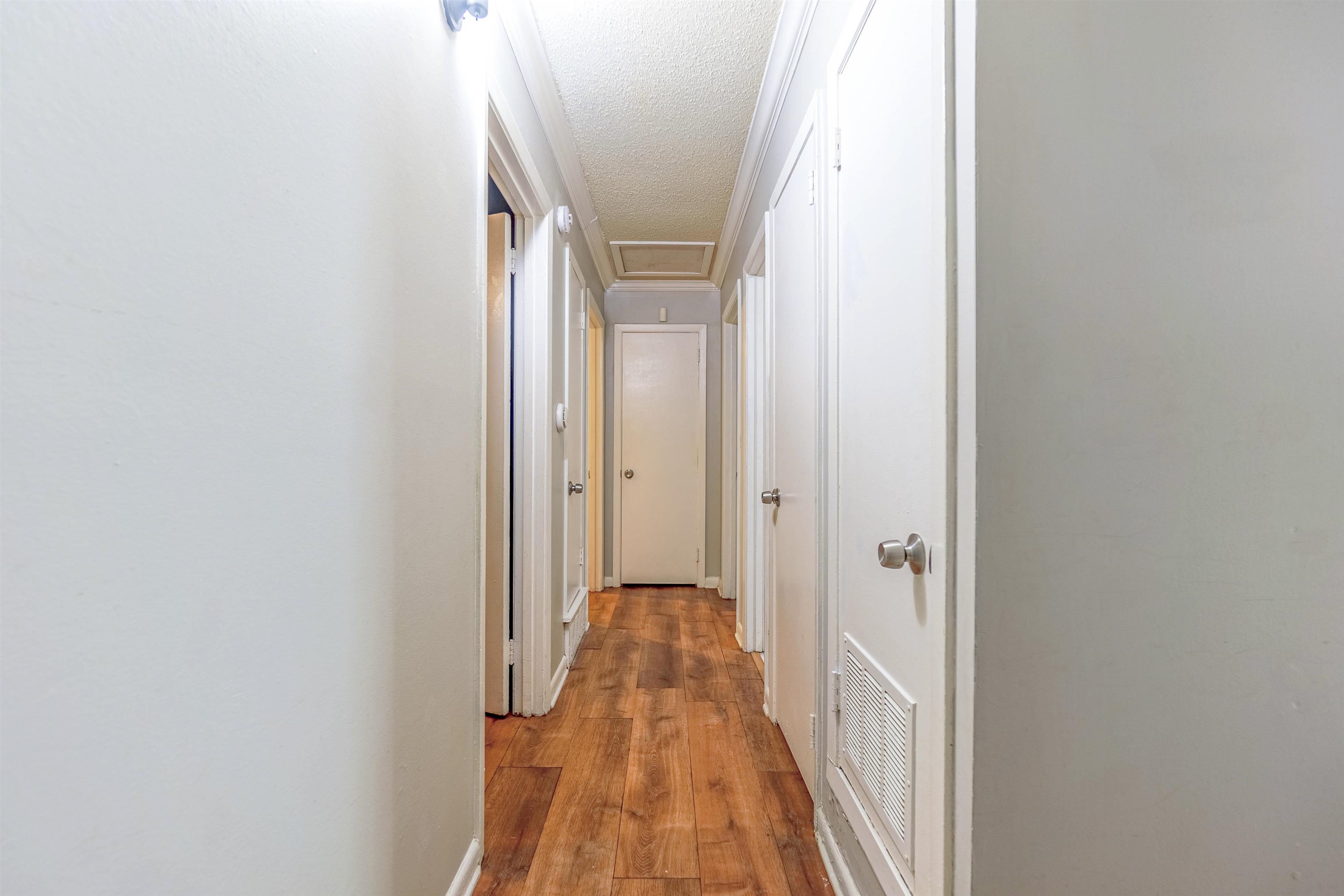 1950 Victoria Road Memphis, TN 38116 - Photo 8 of 25 Hall with light wood-style floors and a textured ceiling