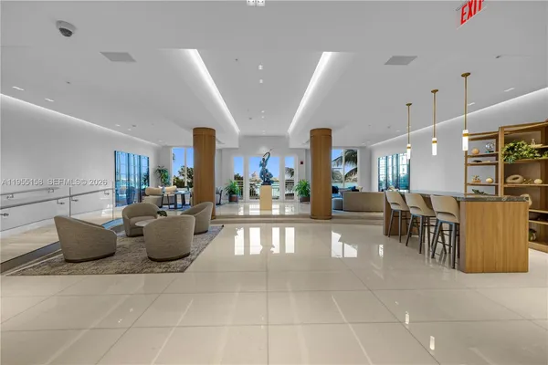 a living room with couches and kitchen view