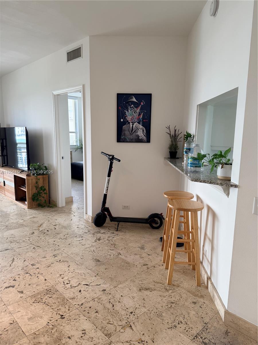 888 Brickell Key Drive, Unit 701 Miami, FL 33131 - Photo 11 of 20 a living room with furniture a flat screen tv and a table