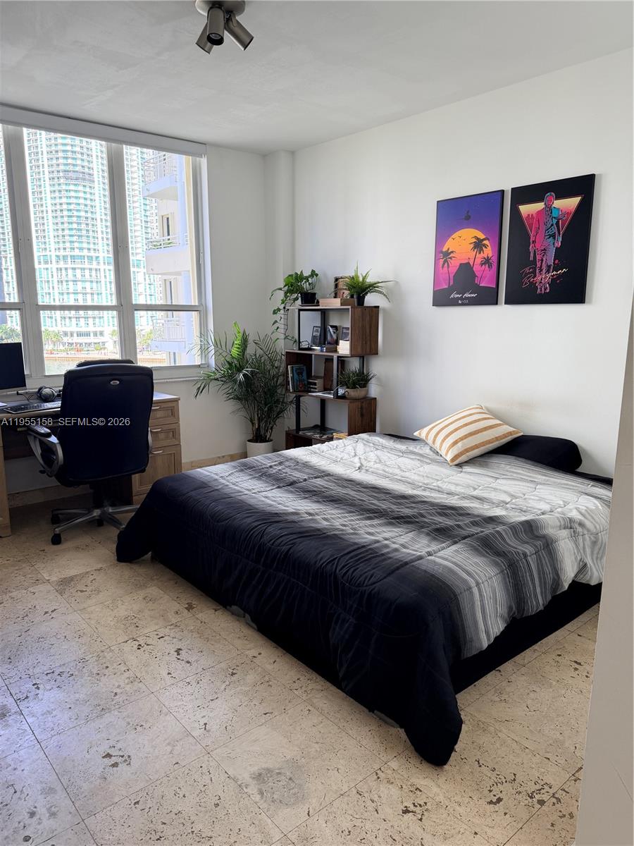 888 Brickell Key Drive, Unit 701 Miami, FL 33131 - Photo 12 of 20 a bedroom with a bed and a couch