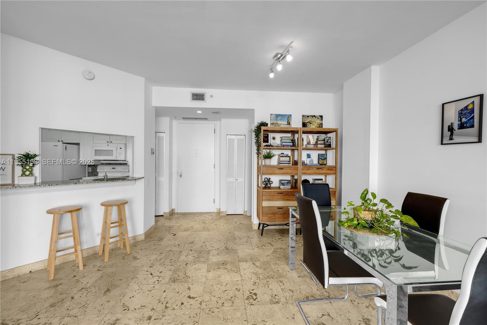888 Brickell Key Drive, Unit 701 Miami, FL 33131 - Photo 15 of 20 a open kitchen with stainless steel appliances kitchen island granite countertop a refrigerator and cabinets