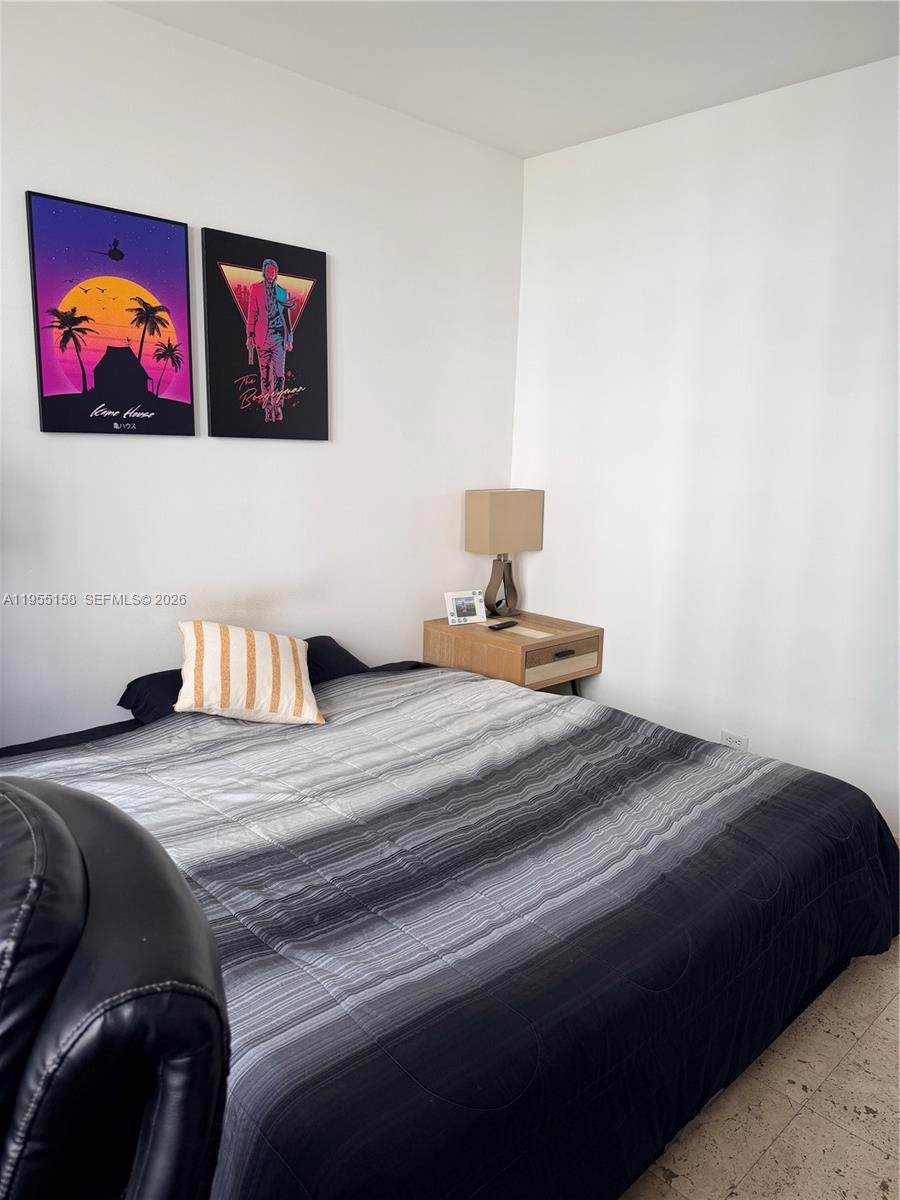 888 Brickell Key Drive, Unit 701 Miami, FL 33131 - Photo 16 of 20 a bedroom with a bed and painting on the wall