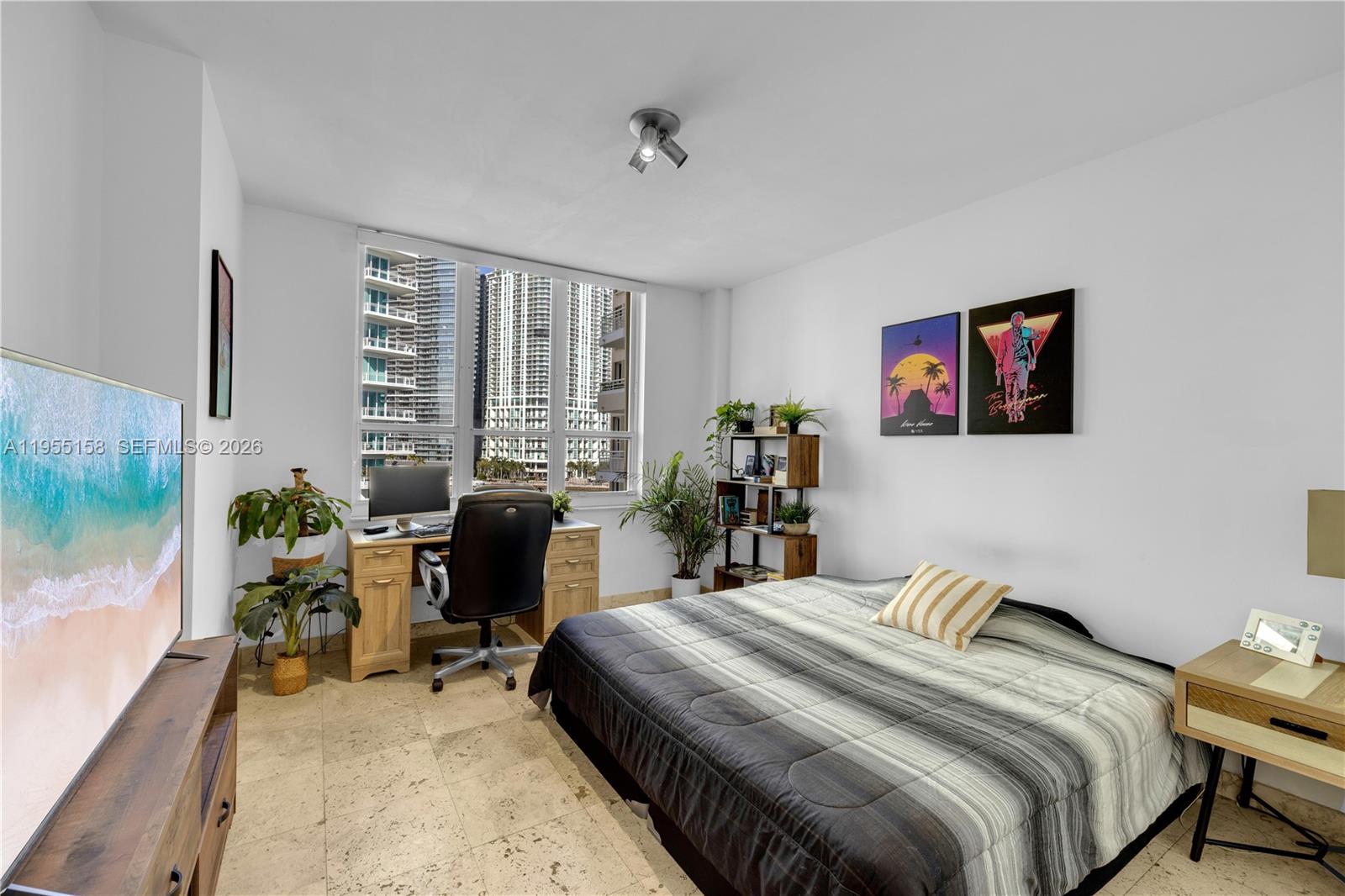 888 Brickell Key Drive, Unit 701 Miami, FL 33131 - Photo 17 of 20 a bedroom with a bed and a couch