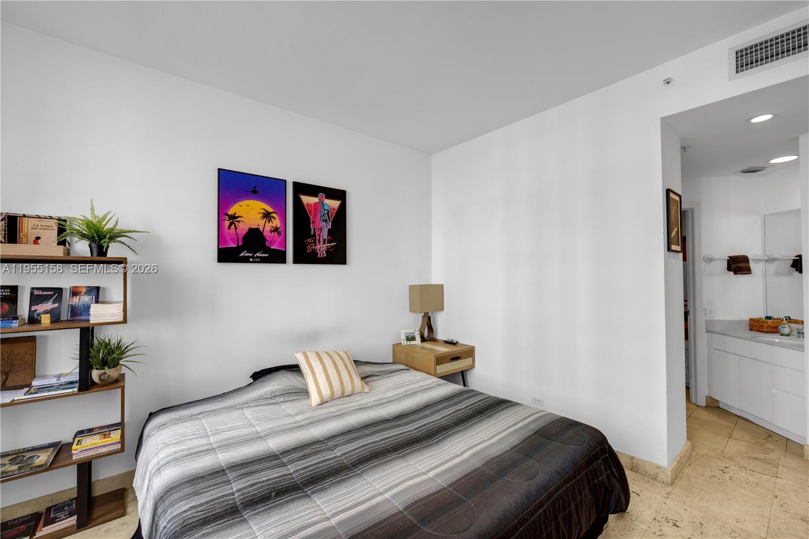 888 Brickell Key Drive, Unit 701 Miami, FL 33131 - Photo 18 of 20 a bedroom with bed and wall painting